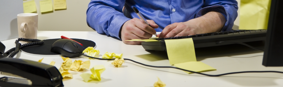 Worker surrounded by post-it notes