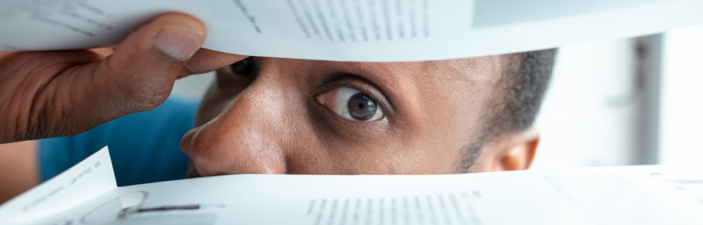 man looking at printed out documents