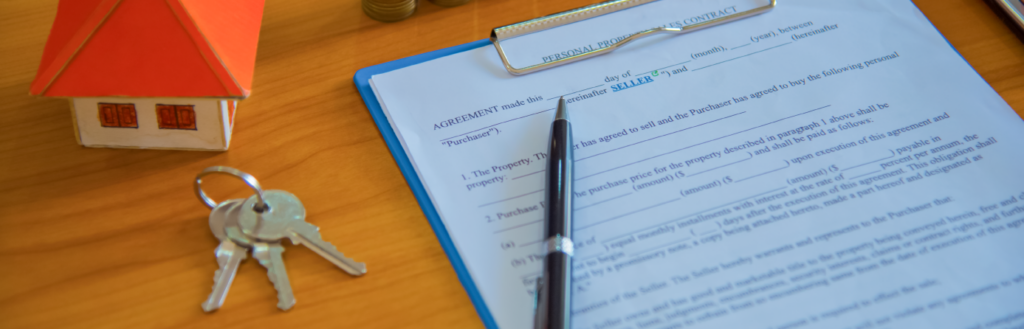 mortgage application document on a desk with keys and a small model house